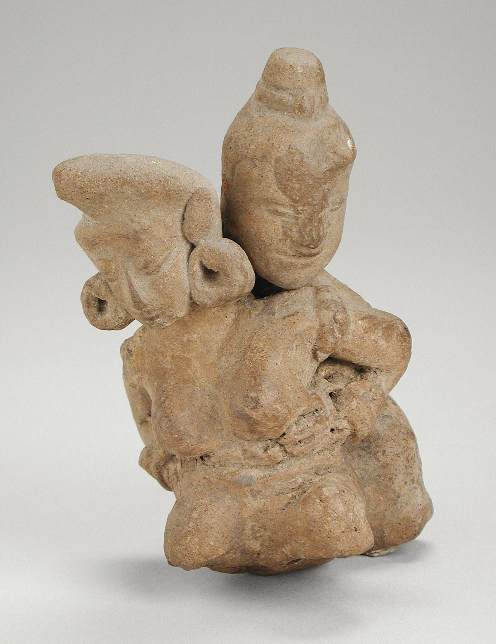 a rock sculpture with wings made out of clay