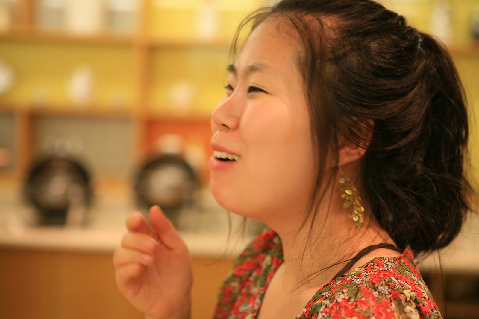 woman in a floral dress smiles happily