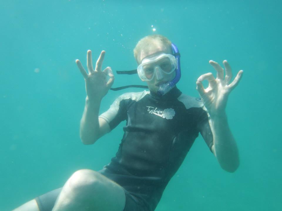 a man in a diving mask diving in the ocean