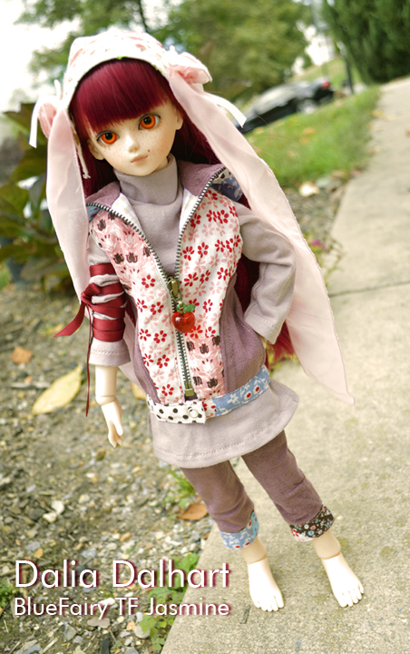 doll standing on sidewalk wearing outfit with flowers
