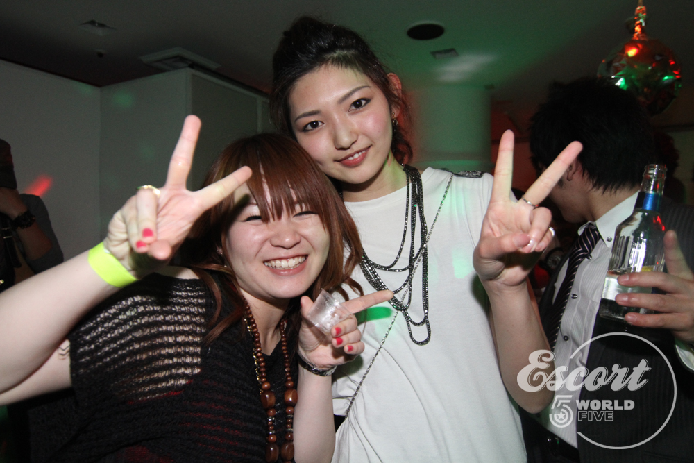 the two girls are posing for the camera while the woman gives their fingers up