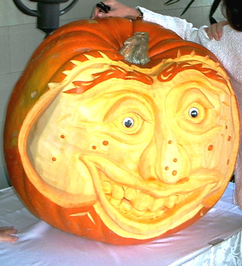 an orange carved pumpkin with a goofy face