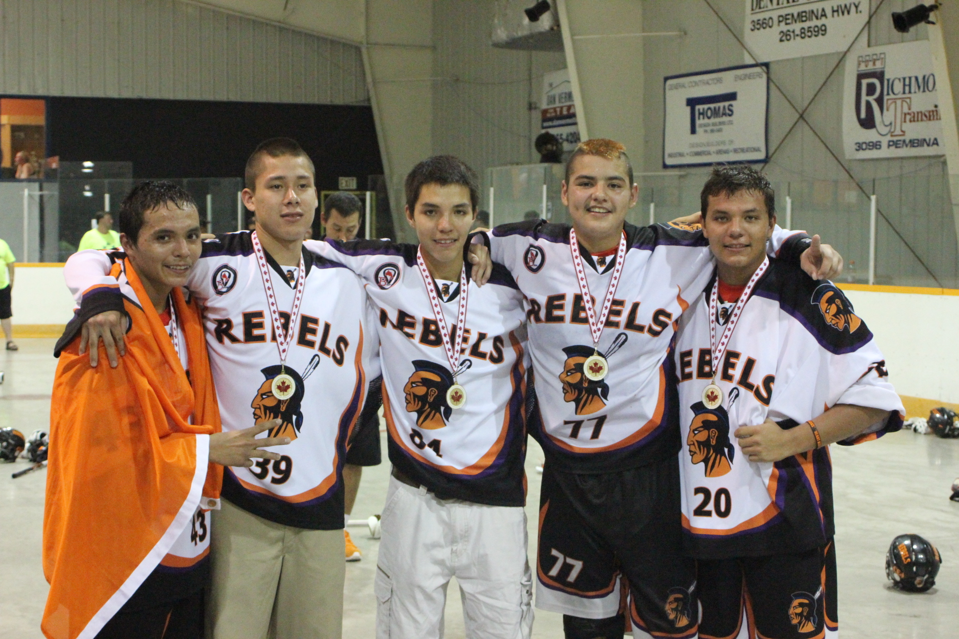 a team of men standing next to each other holding up their jerseys