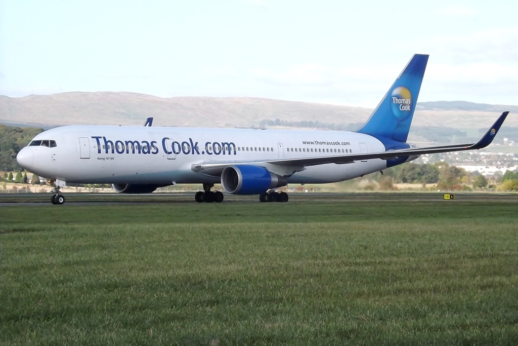 a passenger plane with thomas cook on it's tail