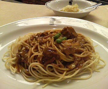 a close up of a plate of pasta with meat