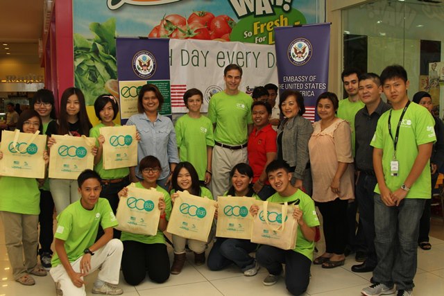 people stand with their bags of food on the floor