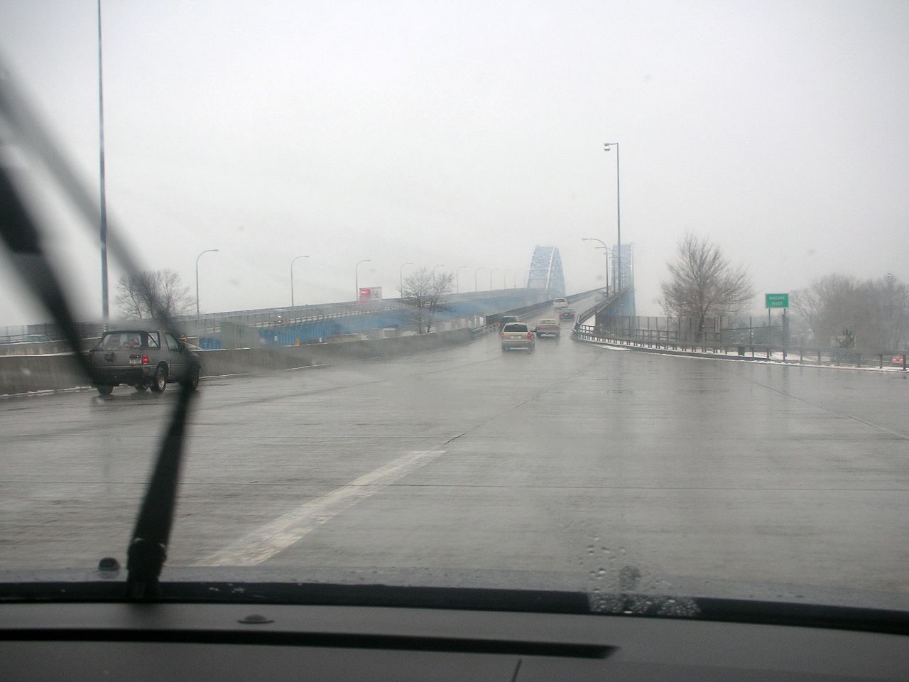 a car driving on a wet road on a gloomy day