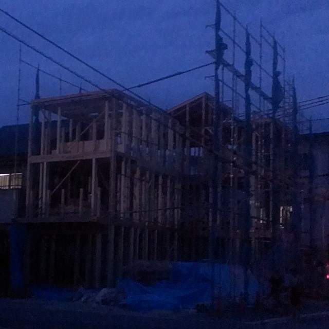 a building is under construction and its lit up at night