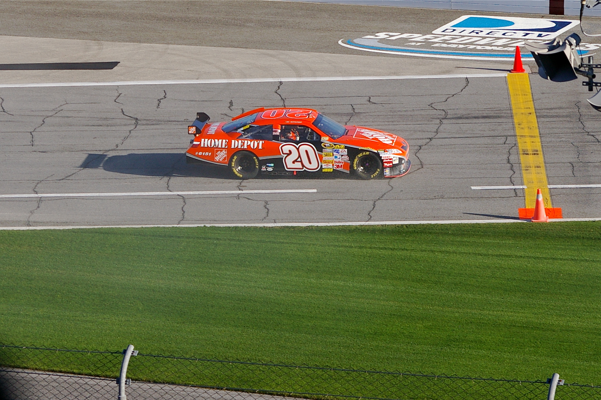 the race car is driving along the track