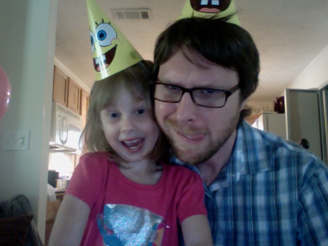 a man and  wearing birthday hats