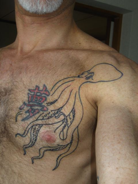 man with chest piece displaying intricate tattoo of octo