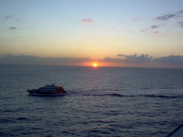 sunset seen from boat leaving the shore