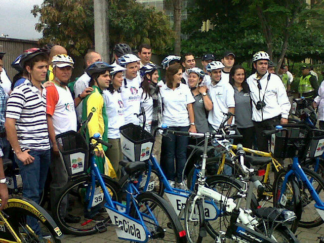 a group of people standing in front of a line with bicycles