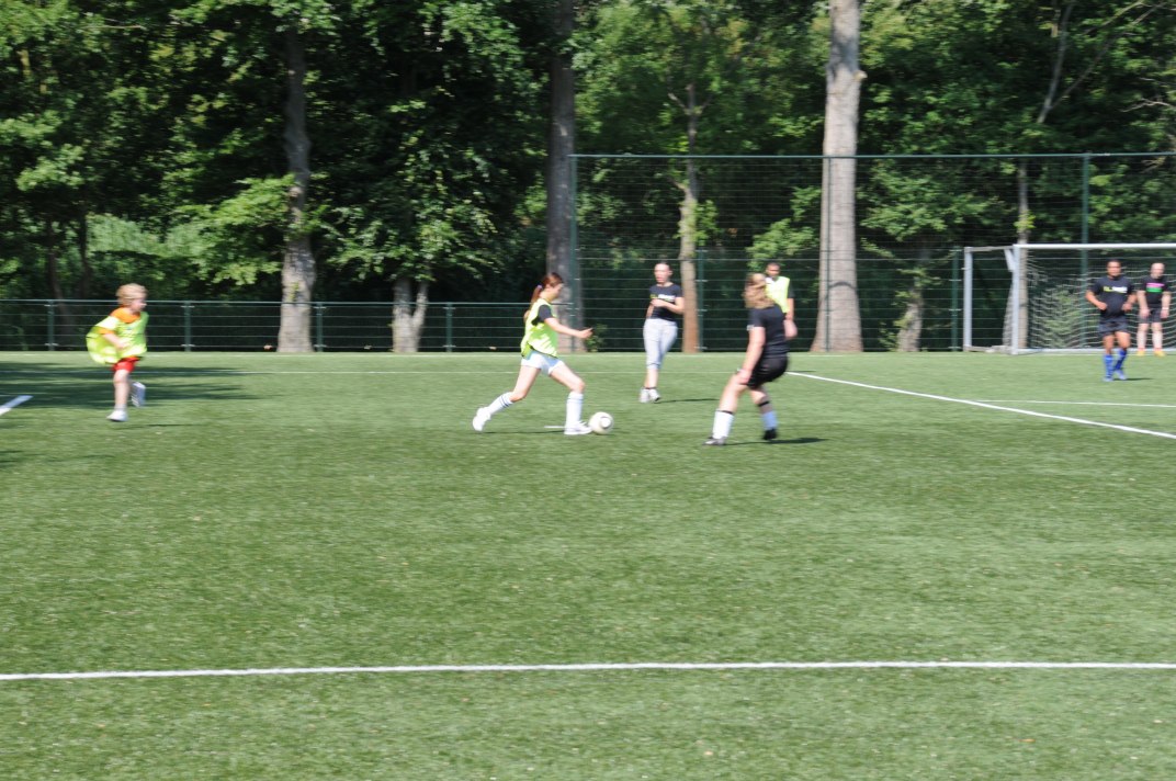 a group of girls in uniforms playing soccer