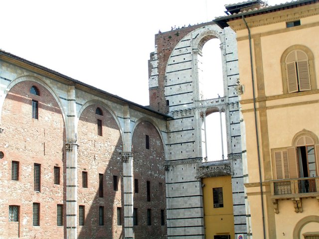 two tall building with arched windows near one another