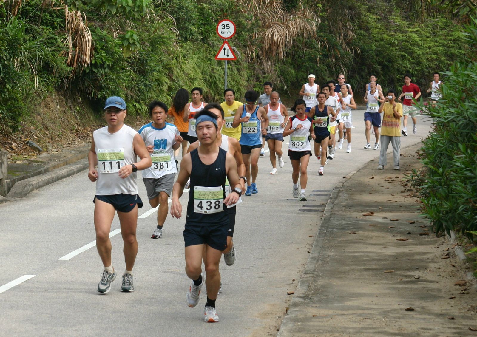 marathon participants run in a race with spectators