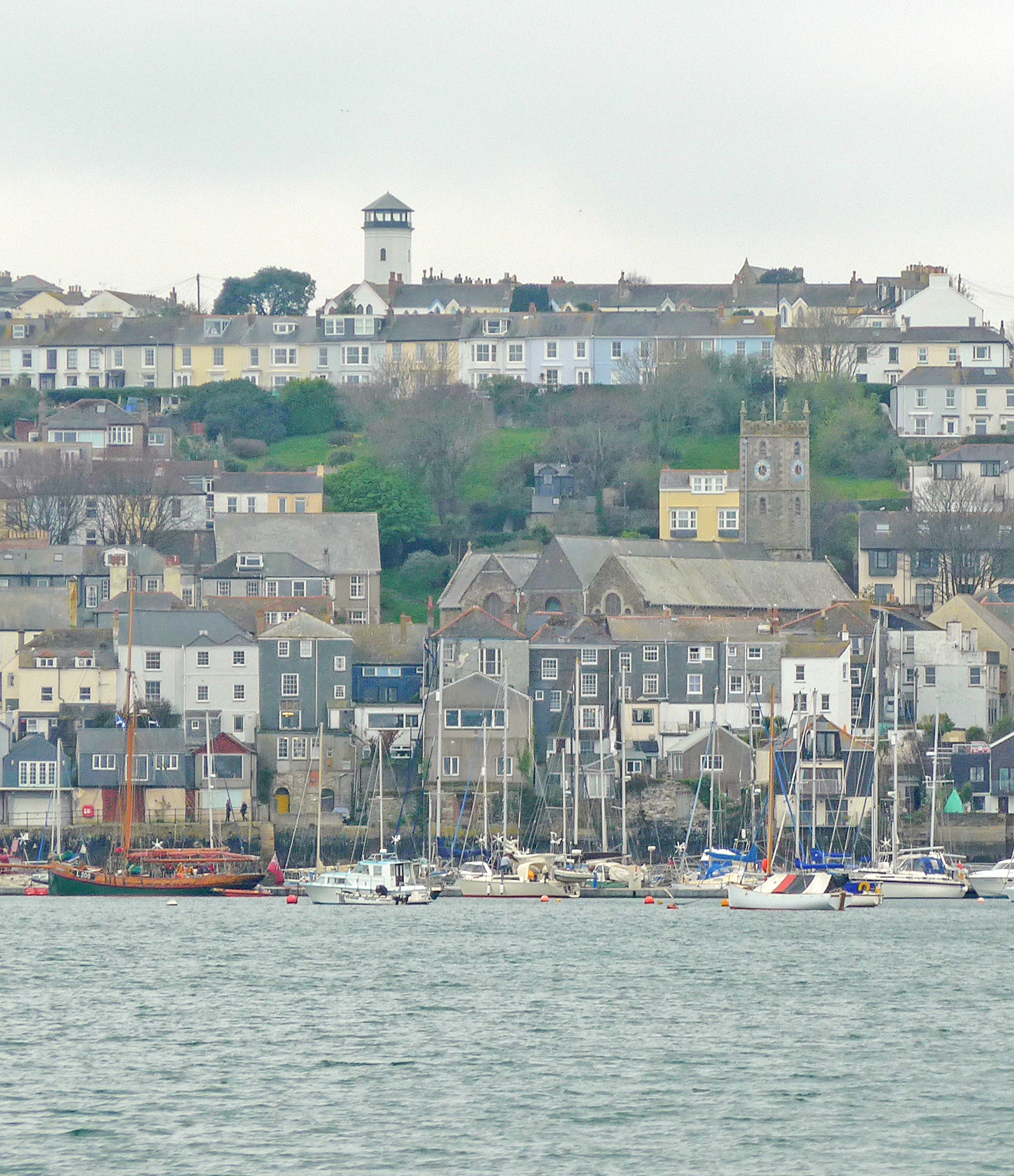 the boats are in the harbor by the city