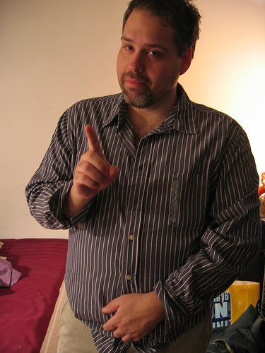 a man is giving the thumbs up while standing