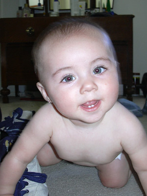 baby posing for camera on carpet in living area