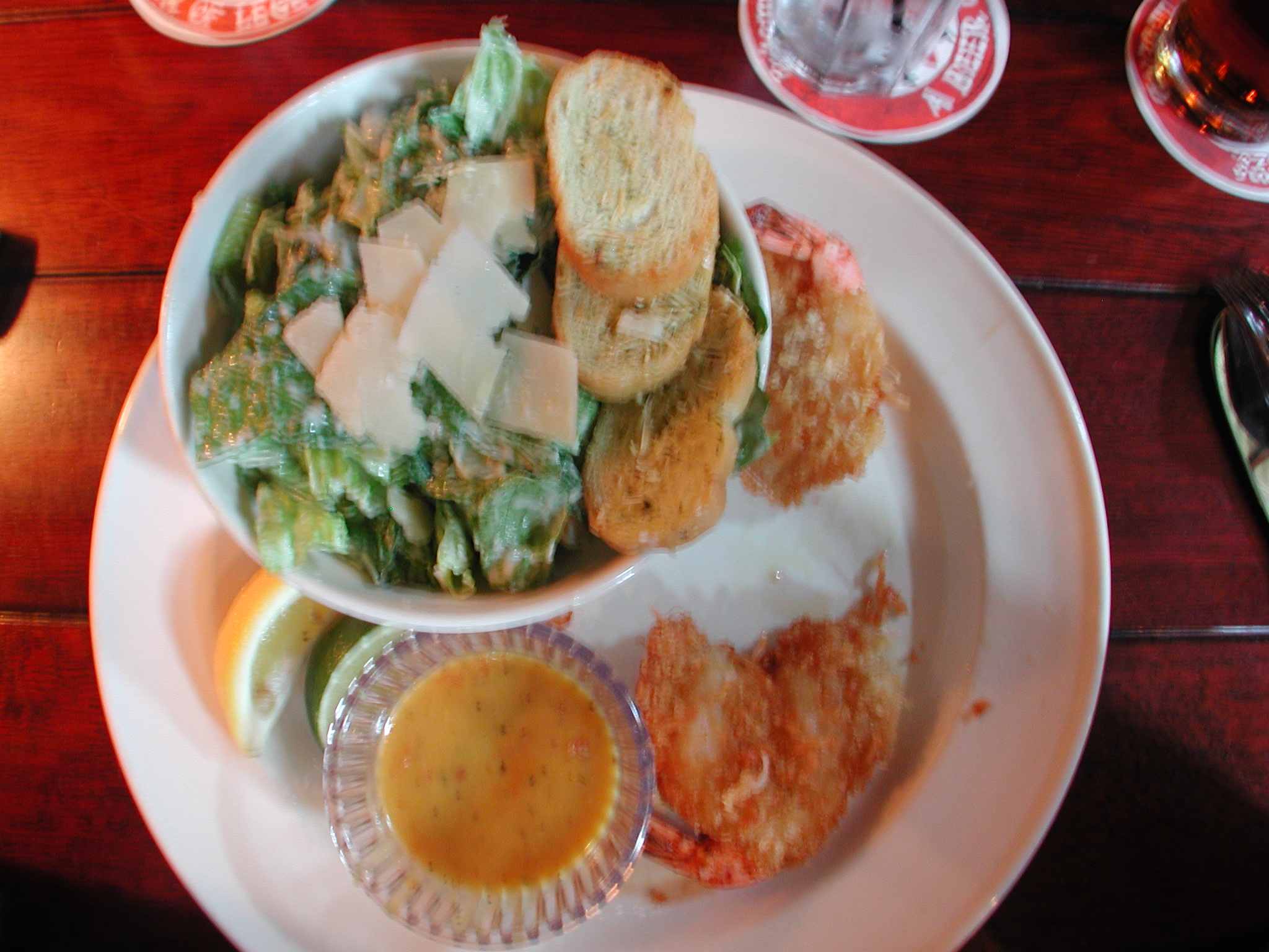 a plate topped with breaded cheeses and salad