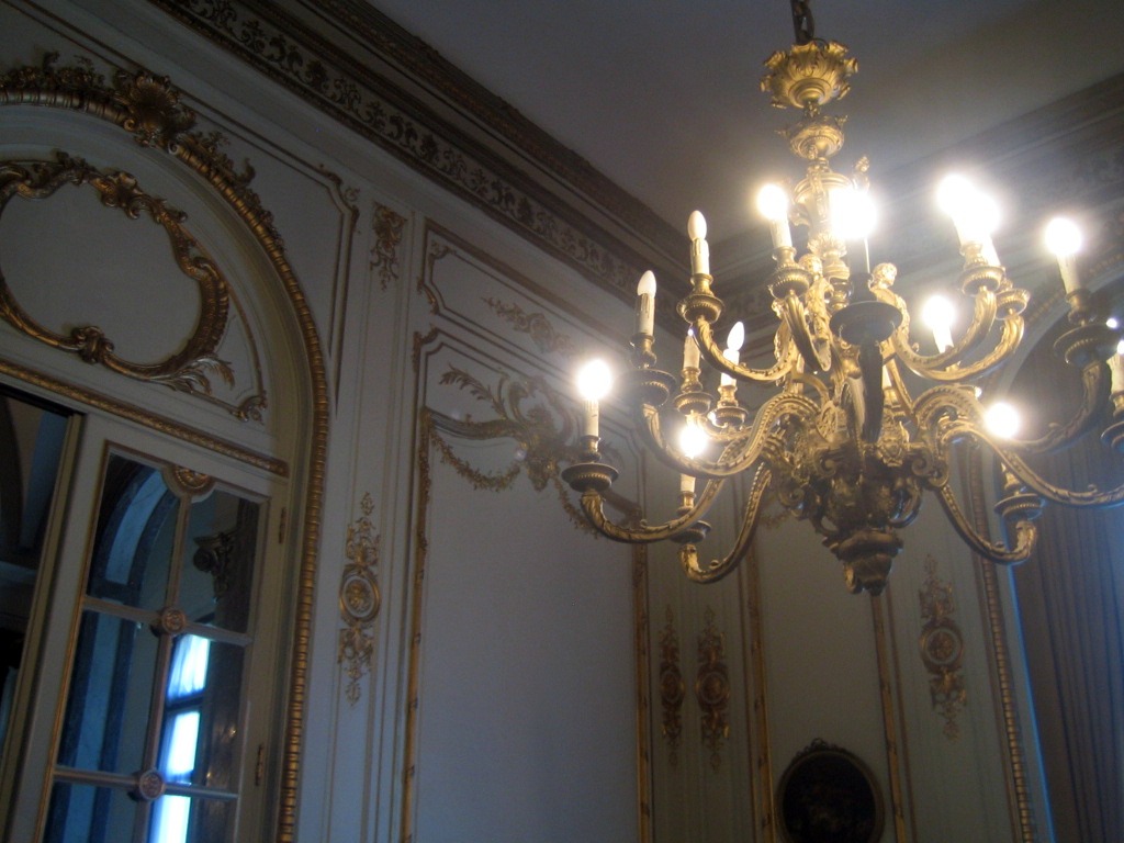 a large ornate light fixture is against the wall