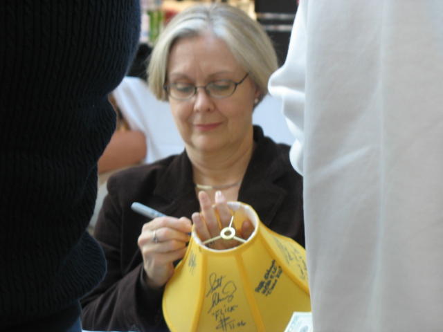 a woman holding a yellow bag near another woman