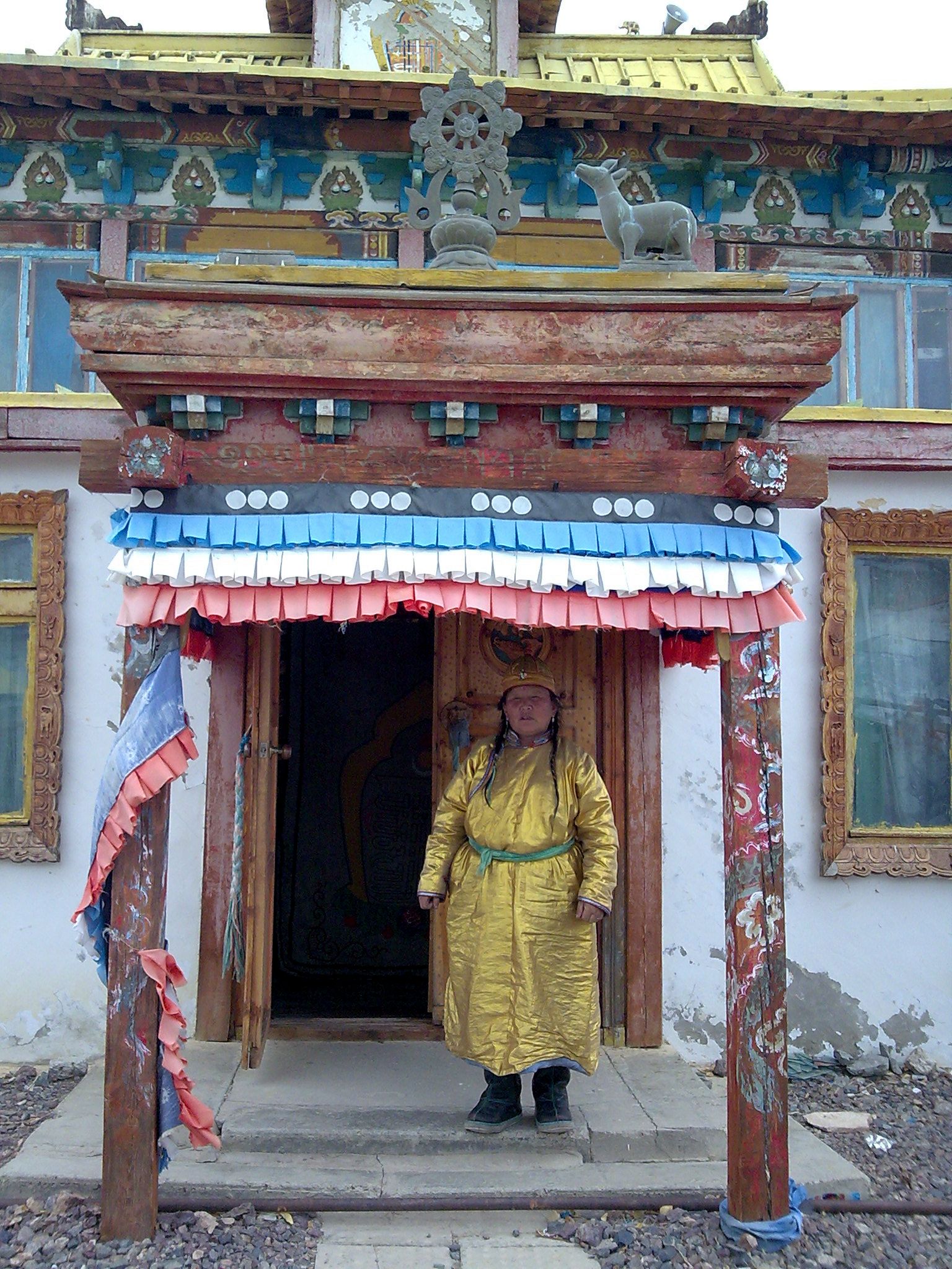 a man standing inside of a chinese building with many decorations