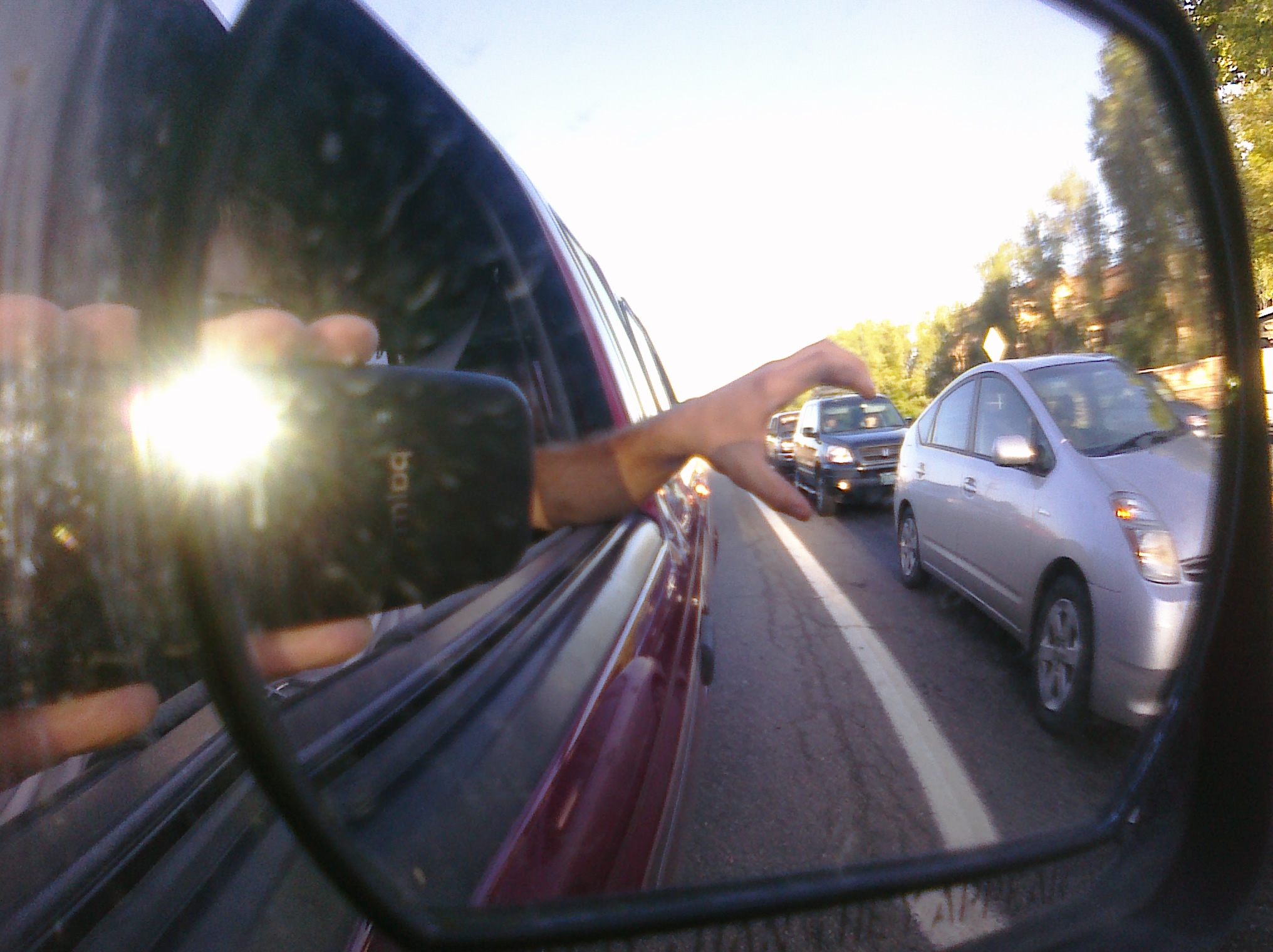 a side mirror that is in the reflection of a car