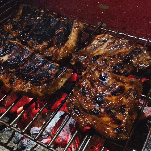 ribs, steaks and fish cooking on the grill