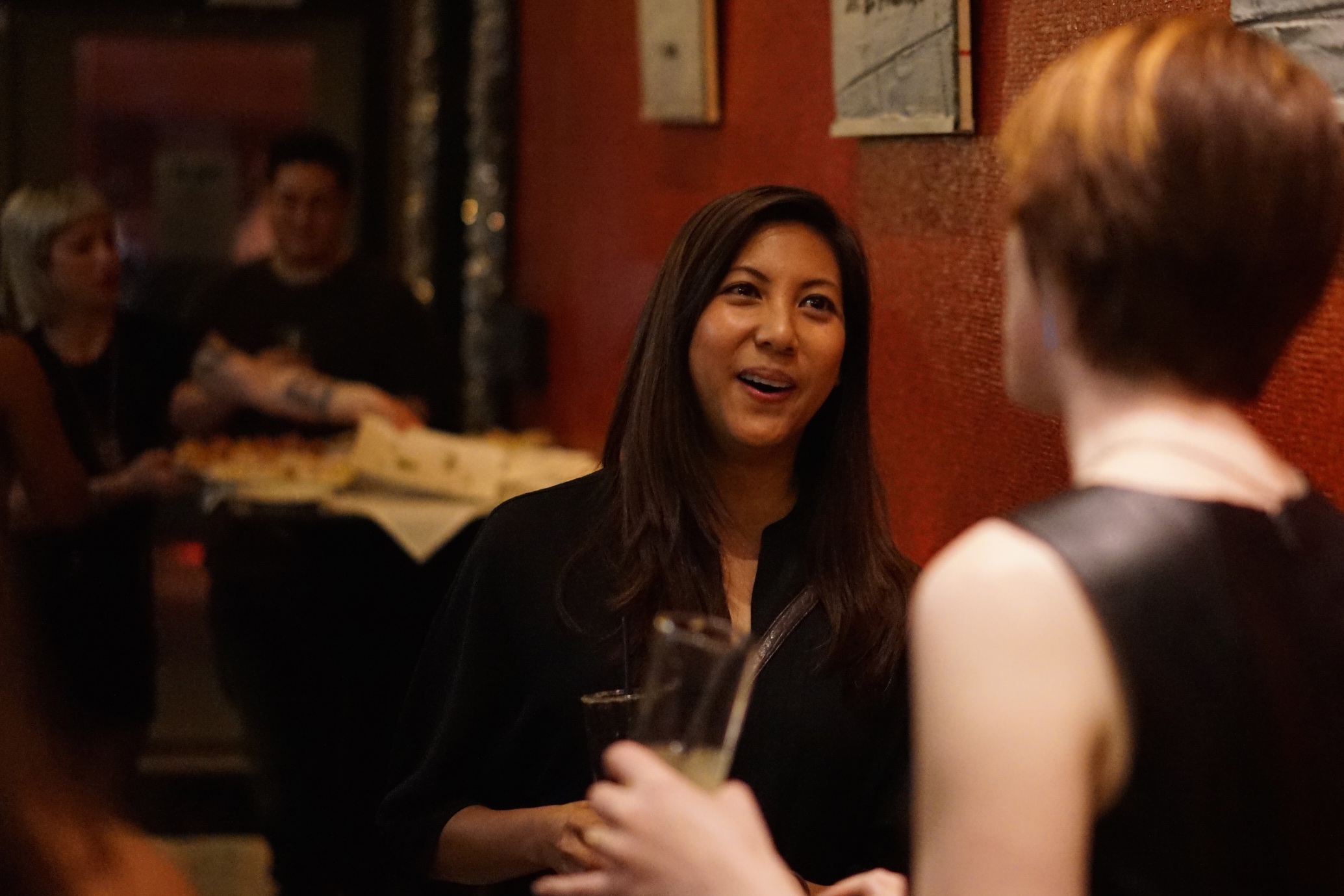 people sitting at a restaurant in a crowded restaurant