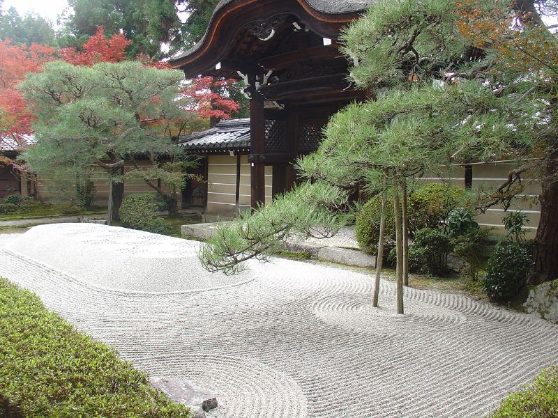 a garden with a pagoda in the background