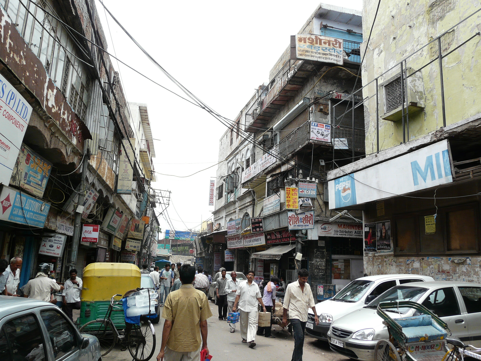 people walking in an asian street next to a building