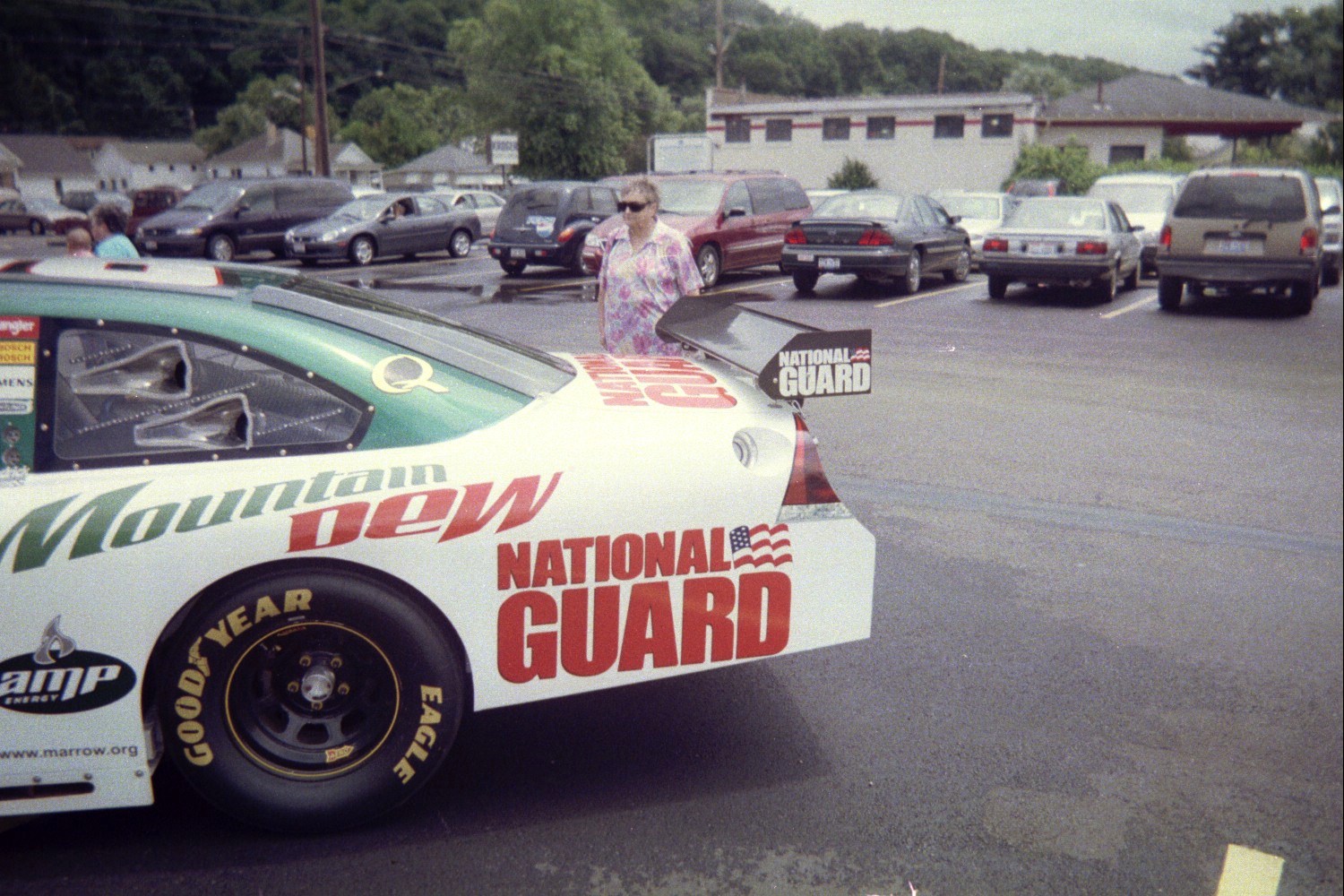 a woman on top of a race car that is parked