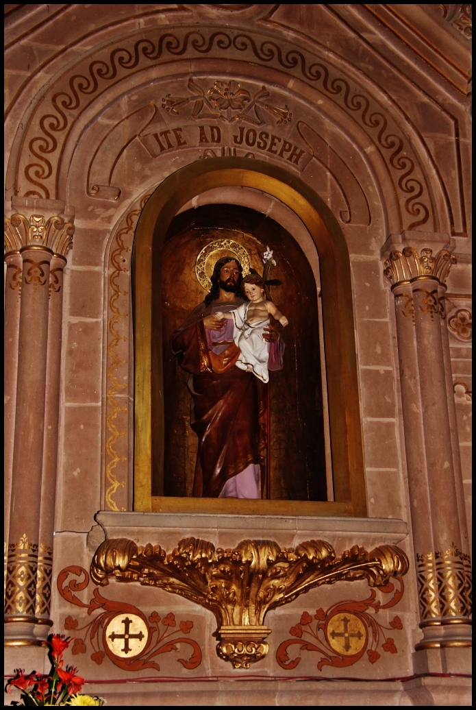 an ornate alter features a large figure in the center