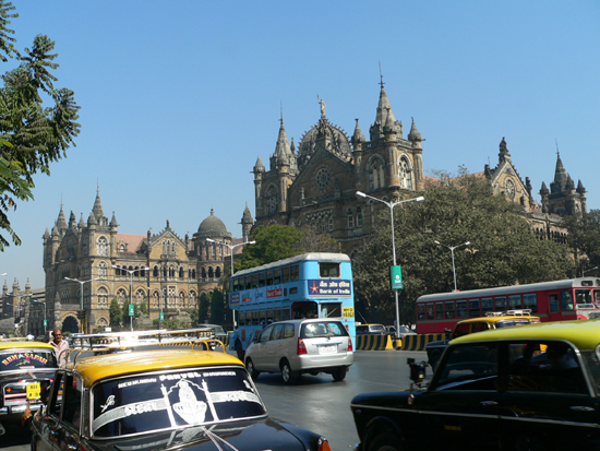 cars, buses, and buses driving on a street