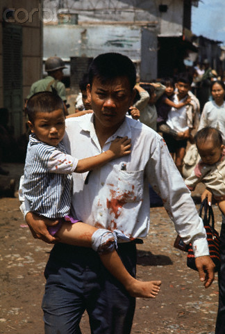 a man carries a baby down the street