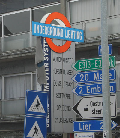 a pole with several road signs sitting on top of it