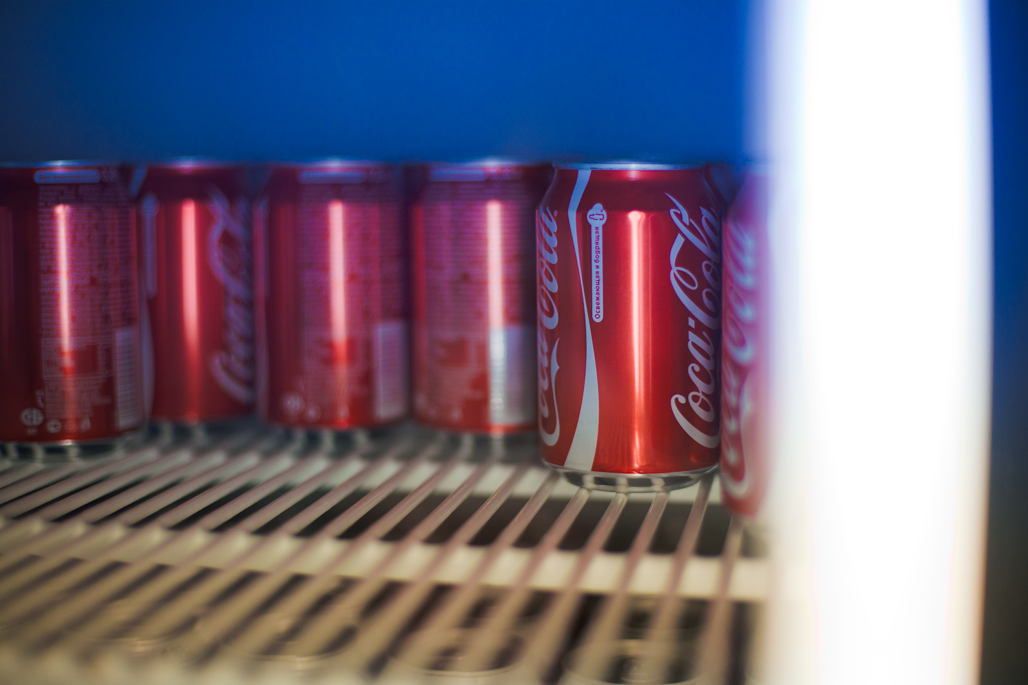 a closeup view of a row of coca - cola cans