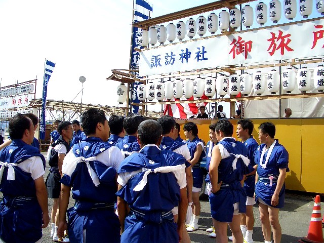 a group of young people with blue uniforms standing in front of a display