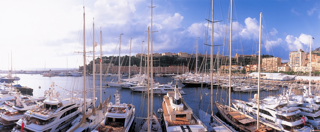 several boats docked in a marina next to city