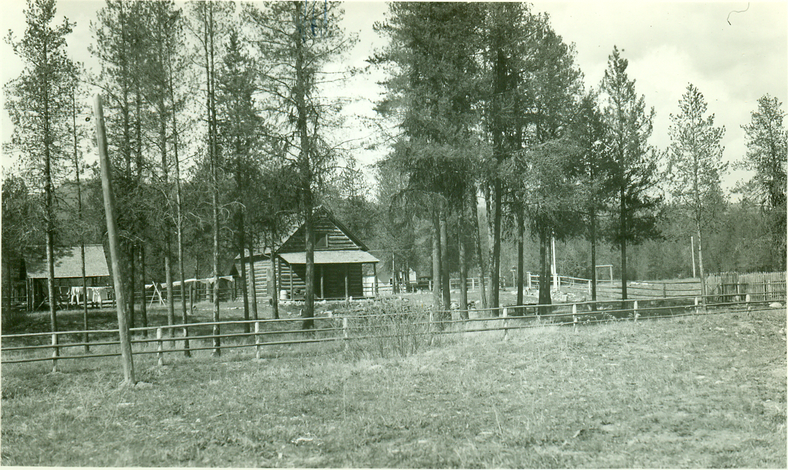 a black and white po of a fence and a wooden shack