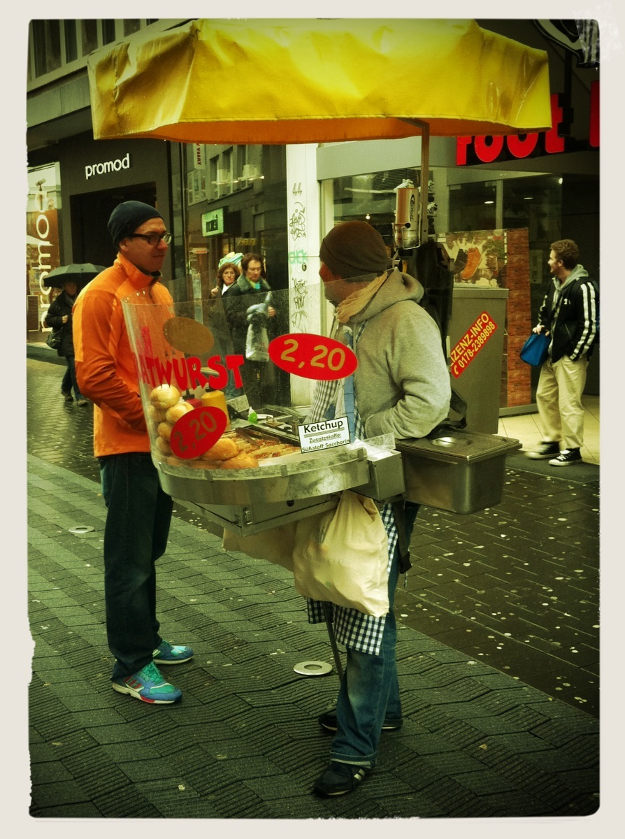 two people are looking at their food on a table