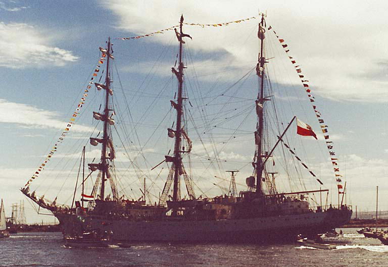 a large sailing ship at sea with flags on the mast