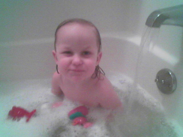 a child who is playing in the bathtub