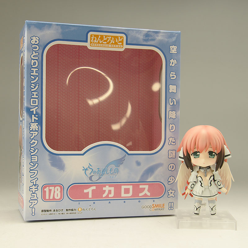 a plastic box containing an anime figurine stands in front of it