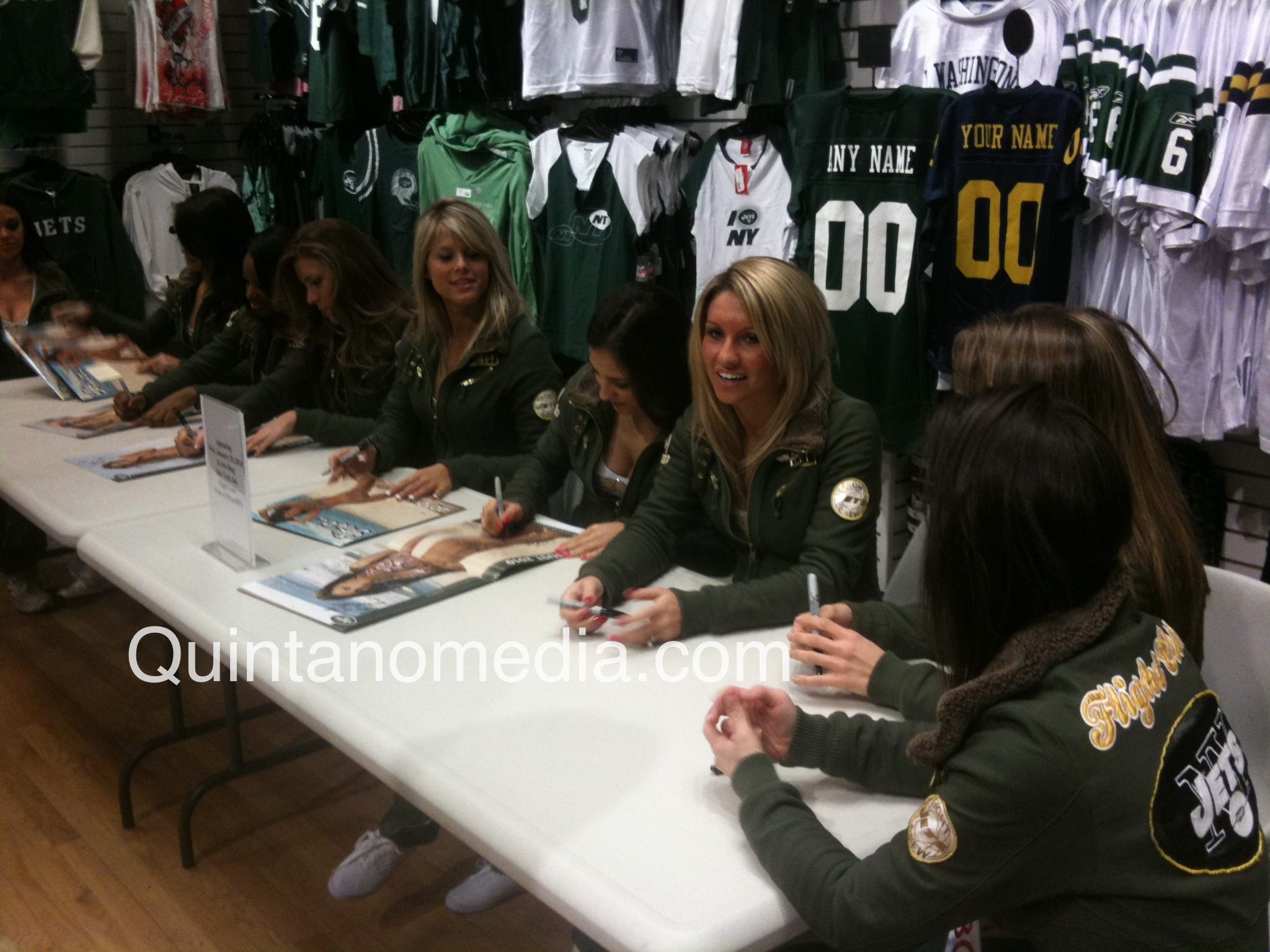 young women signing autographs at a sporting store