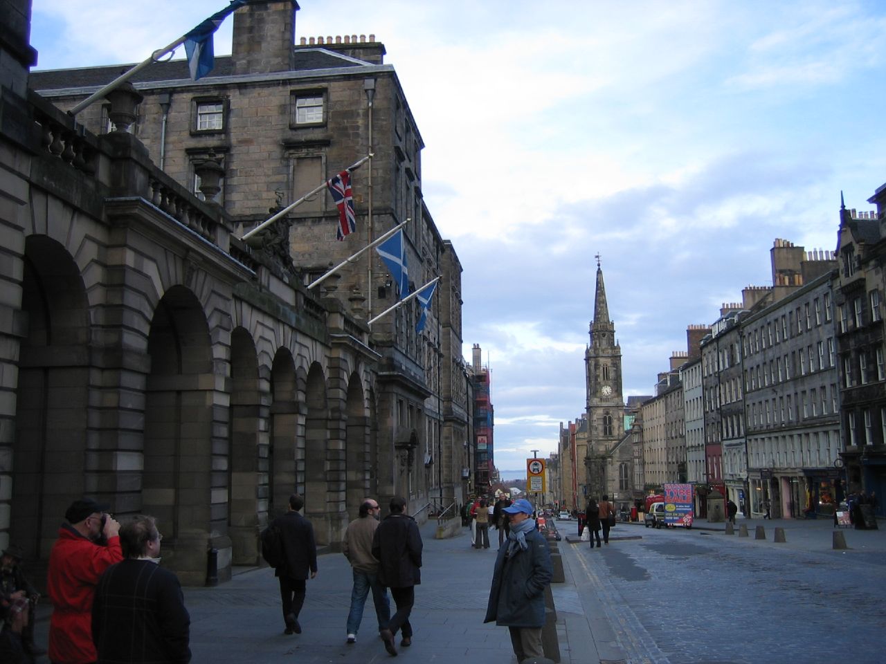 many people walking along the side of a road