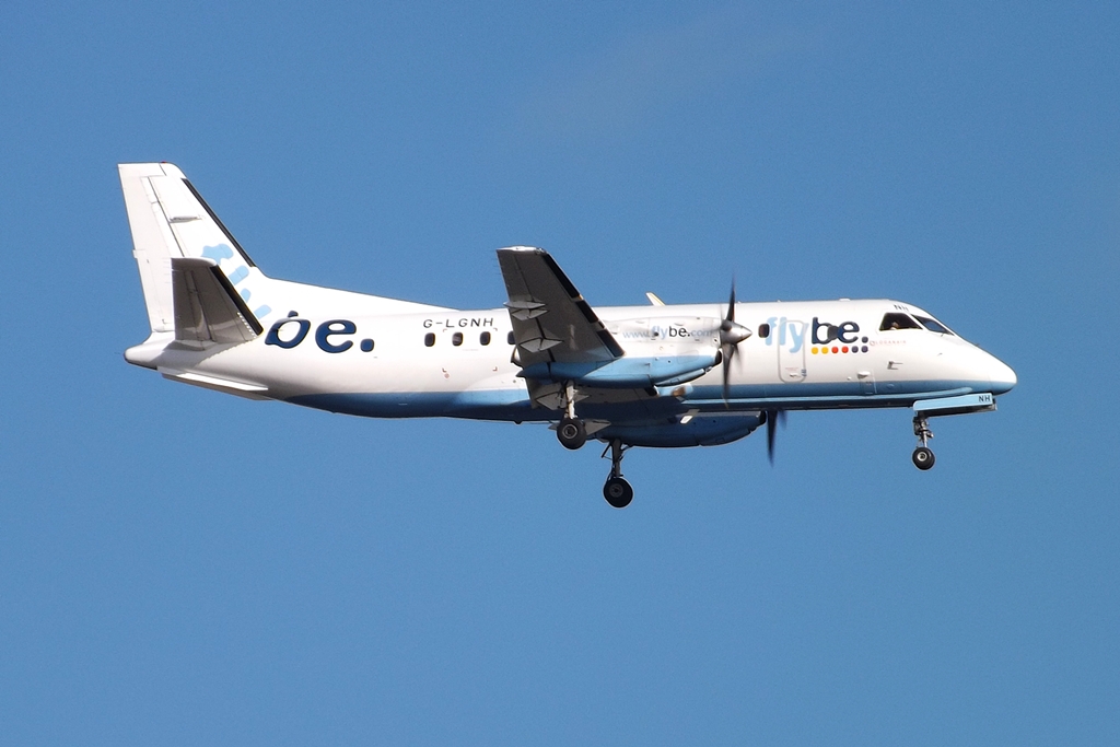 a jet airliner flying through a blue sky