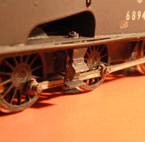 the wheels of a toy train laying on the ground