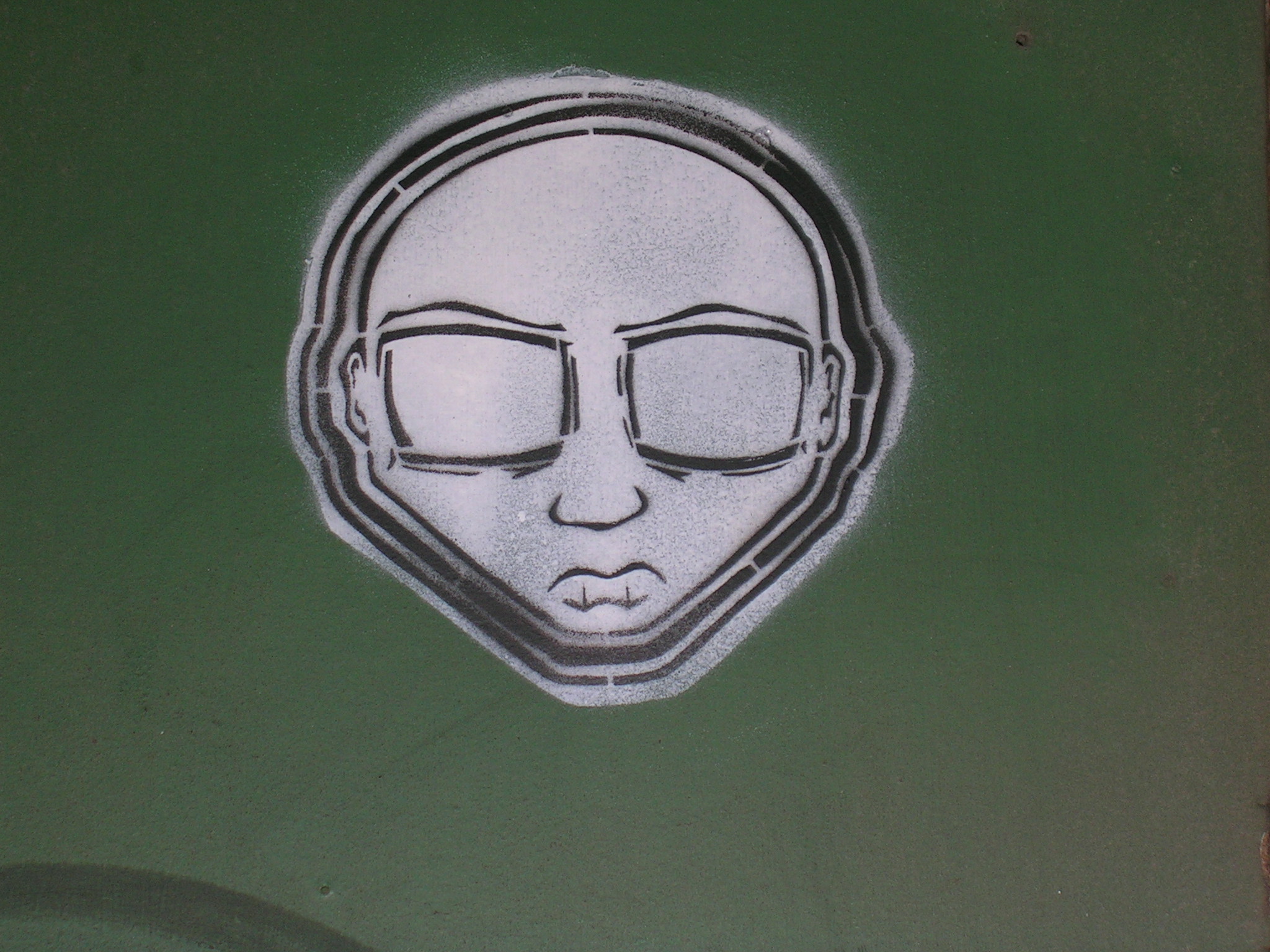 a grafitti painting of a man with glasses